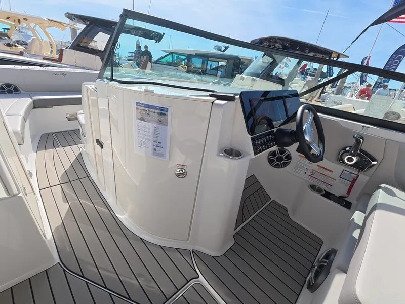 Slide: The Image of The image shows the cockpit of a Sea Ray SDX 270 Outboard boat with modern instruments and sleek design. - 16