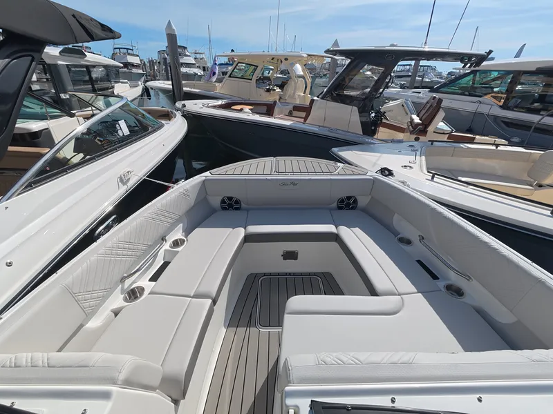 Slide: The Image of The image shows the spacious cockpit of a Sea Ray SDX 270 Outboard, surrounded by other boats in a marina. - 21