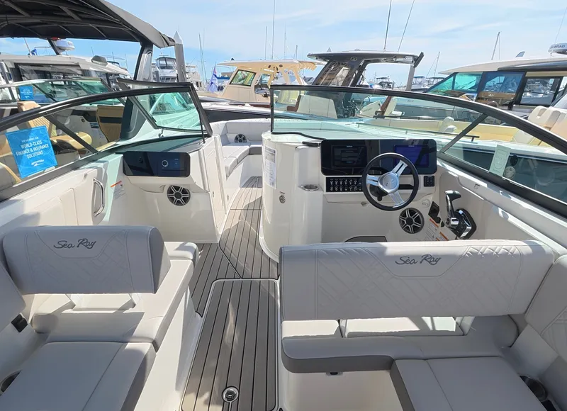 Slide: The Image of The image shows the cockpit of a 2027 Sea Ray SDX 270 Outboard boat with sleek seating and modern controls. - 13