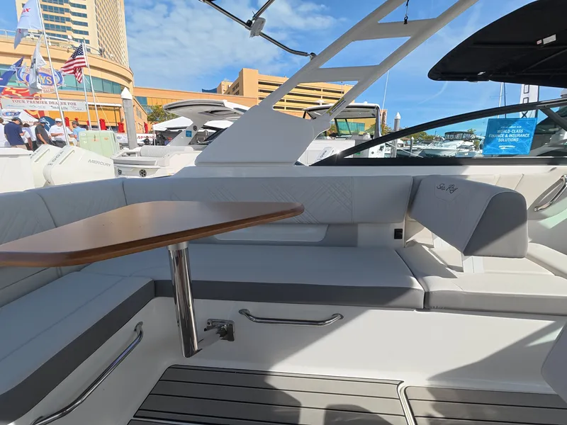 Slide: The Image of The image shows the cockpit of a Sea Ray SDX 270 Outboard with a wooden table and cushioned seating. - 11
