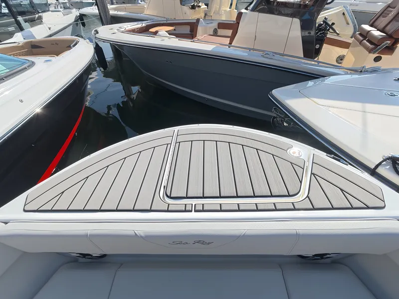 Slide: The Image of The image shows the deck of a 2027 Sea Ray SDX 270 Outboard, docked in a marina. - 22