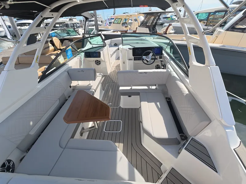 Slide: The Image of The image shows the cockpit of a Sea Ray SDX 270 Outboard with sleek seating and a wooden table. - 7