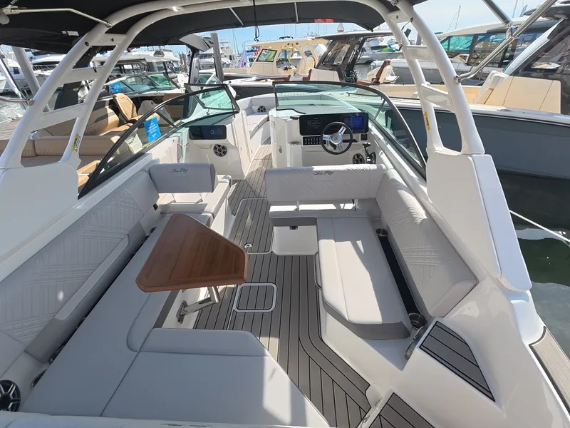 Slide: The Image of The image shows the cockpit of a 2027 Sea Ray SDX 270 Outboard with luxurious seating and a wooden table. - 6