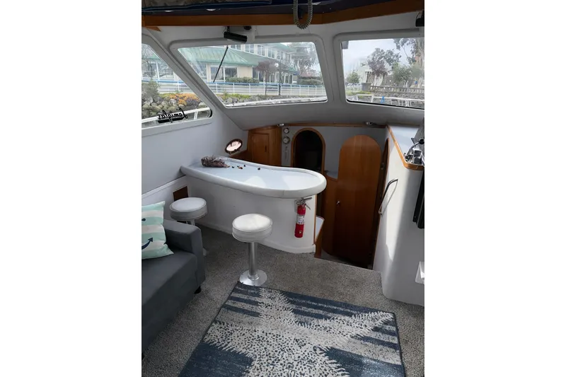 Slide: The Image of Interior of a 1990 Mediterranean Sport Fish boat with seating and a small table. - 11