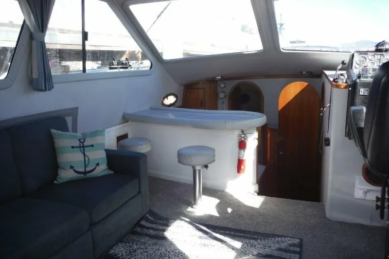 Slide: The Image of Interior of a 1990 Mediterranean Sport Fish boat with seating and helm. - 12