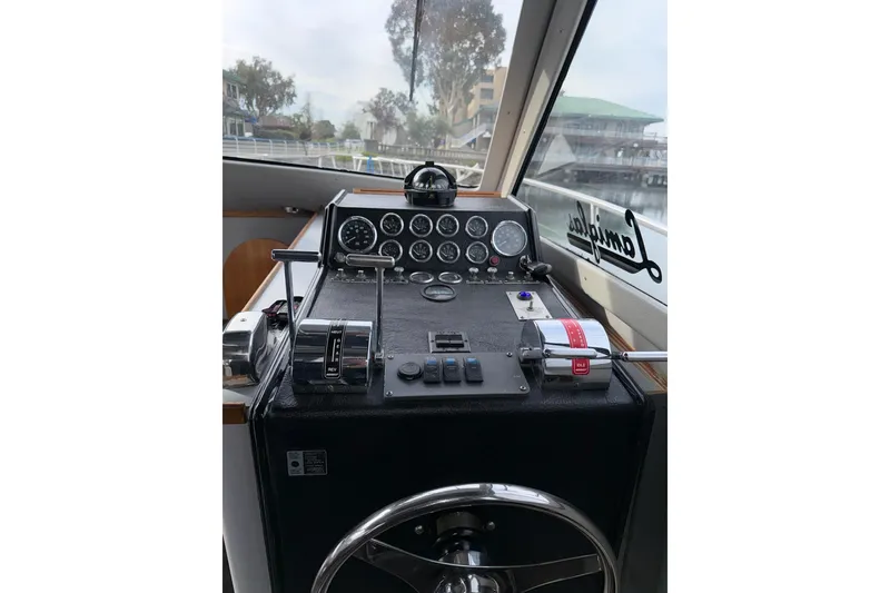Slide: The Image of Cockpit of a 1990 Mediterranean Sport Fish boat with control panel and steering wheel. - 13