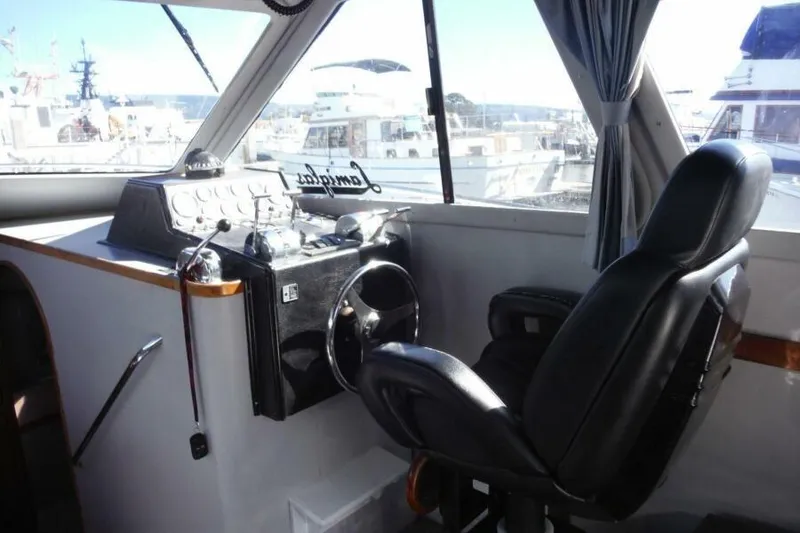 Slide: The Image of Cockpit of 1990 Mediterranean Sport Fish boat with steering wheel and control panel. - 14