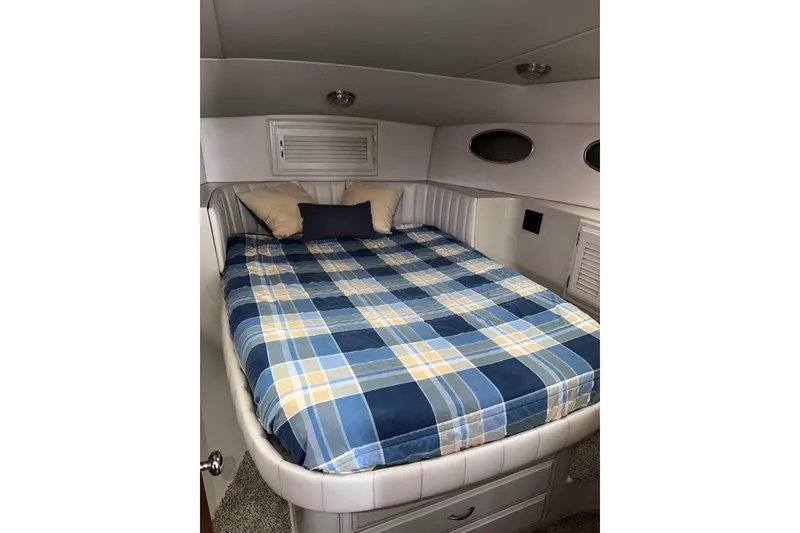 Slide: The Image of Cozy cabin interior of 1990 Mediterranean Sport Fish boat with plaid bedding. - 17