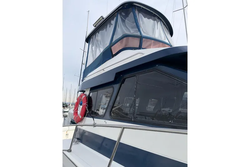 Slide: The Image of 1990 Mediterranean Sport Fish boat with blue accents and a red life preserver. - 4