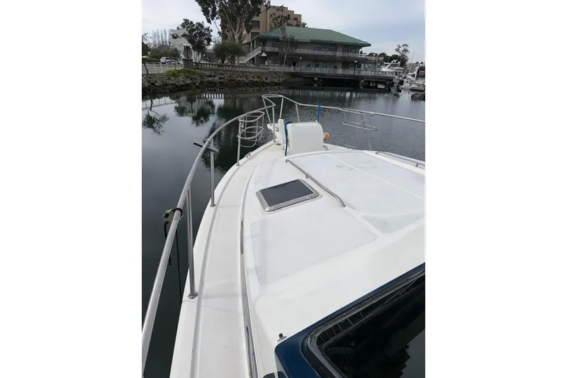 Slide: The Image of 1990 Mediterranean Sport Fish boat docked in a serene marina setting. - 5
