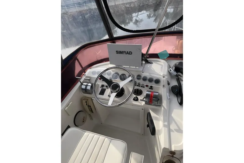 Slide: The Image of Helm of 1990 Mediterranean Sport Fish boat with steering wheel and navigation equipment. - 8