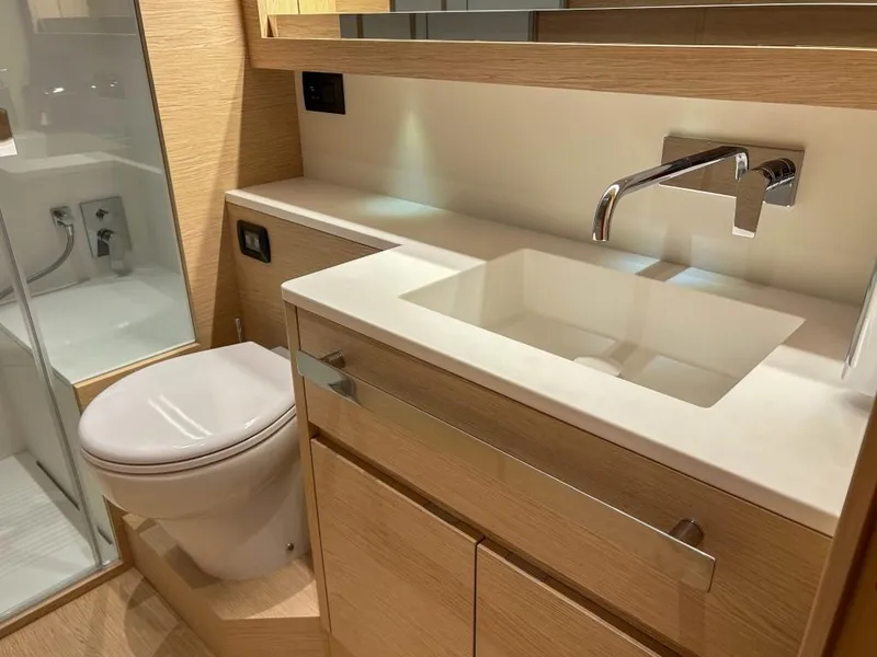 Slide: The Image of Modern bathroom in 2024 Solaris Power 52 Open yacht with sleek fixtures and wooden cabinetry. - 33