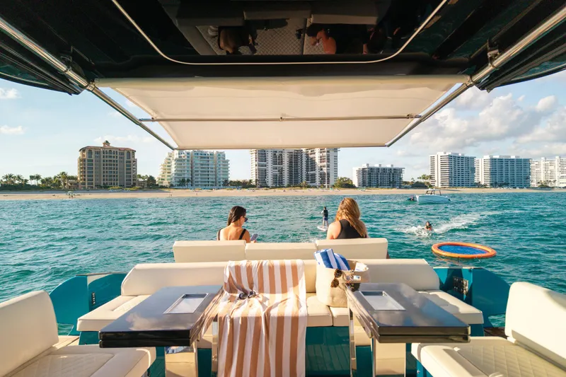Slide: The Image of 2024 Solaris Power 52 Open yacht with beach view, people relaxing onboard. - 35