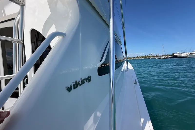 Slide: The Image of 2012 Viking 50 Convertible yacht on calm blue waters, sunny day. - 16