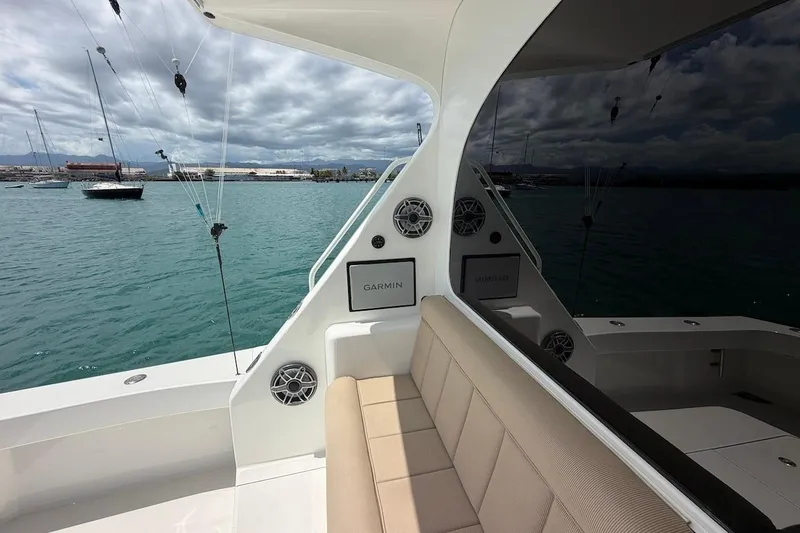 Slide: The Image of 2012 Viking 50 Convertible yacht interior with seating and marine electronics, docked in a marina. - 17