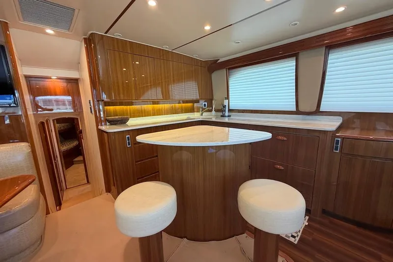 Slide: The Image of Luxurious interior of a 2012 Viking 50 Convertible yacht with elegant wood finishes and modern amenities. - 23