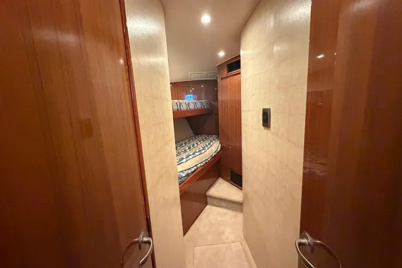Slide: The Image of Interior cabin of 2012 Viking 50 Convertible yacht with bunk beds and wooden finish. - 33