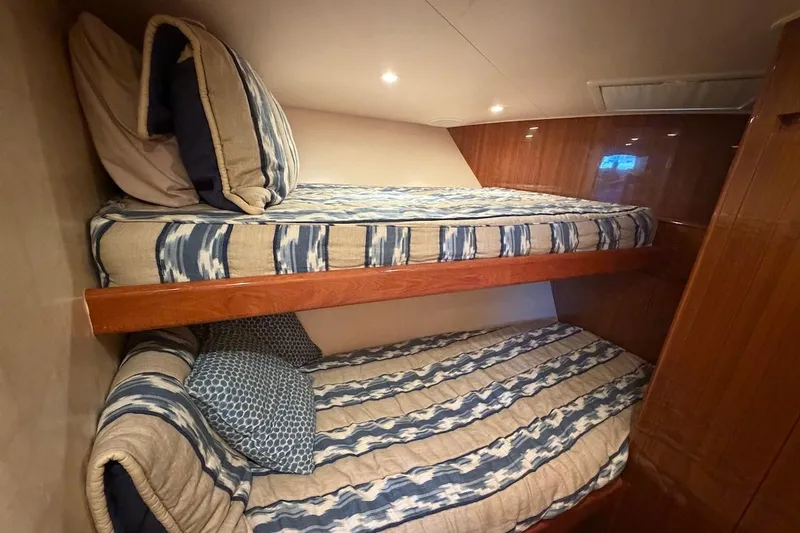 Slide: The Image of Bunk beds in 2012 Viking 50 Convertible yacht cabin with striped bedding. - 35