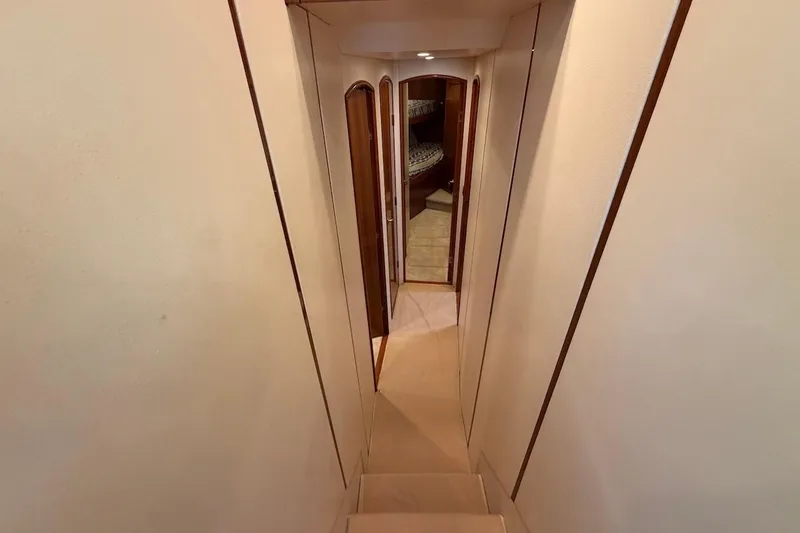Slide: The Image of Interior hallway of 2012 Viking 50 Convertible yacht, featuring elegant wood accents. - 36