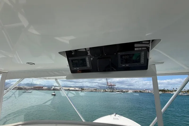 Slide: The Image of Interior view of 2012 Viking 50 Convertible yacht with navigation equipment and ocean backdrop. - 41