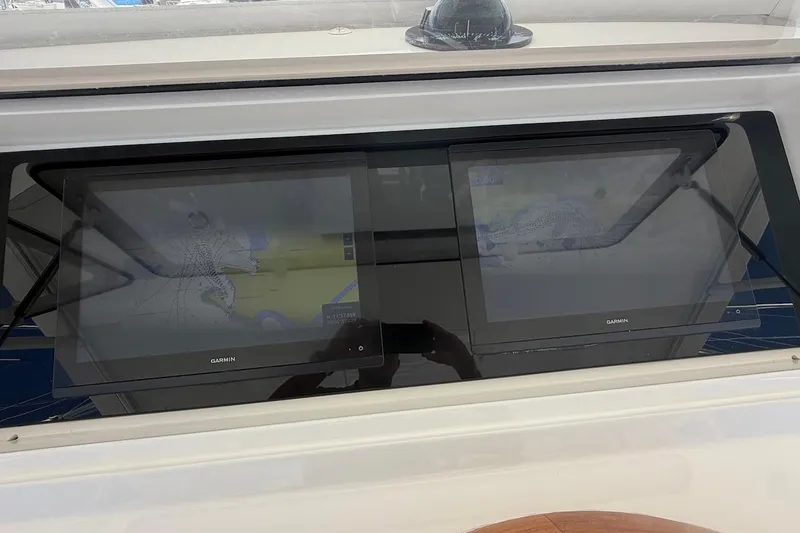 Slide: The Image of Garmin navigation screens on a 2012 Viking 50 Convertible yacht dashboard. - 43