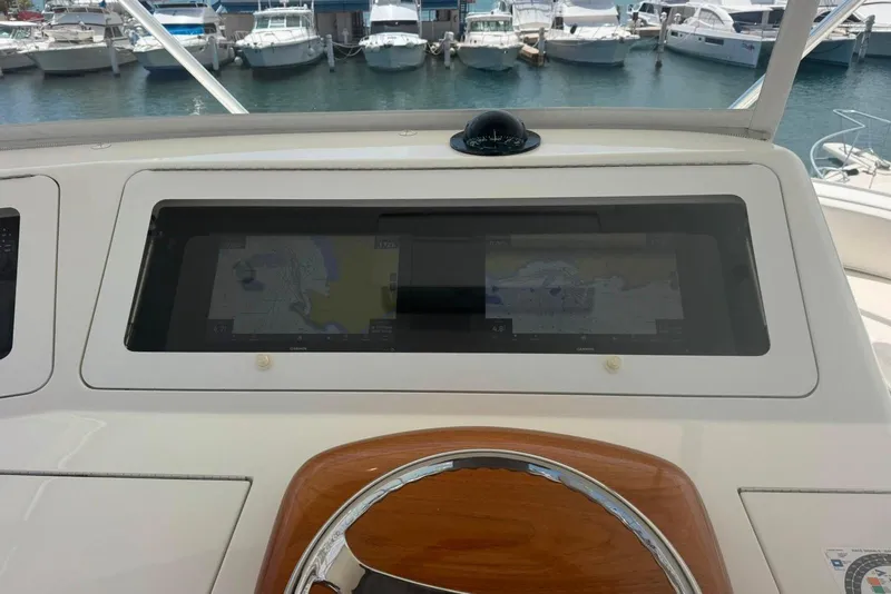 Slide: The Image of Helm of 2012 Viking 50 Convertible yacht with navigation screens and compass. - 44