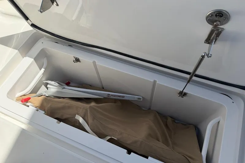 Slide: The Image of Storage compartment on a 2012 Viking 50 Convertible boat with anchor and cover. - 53