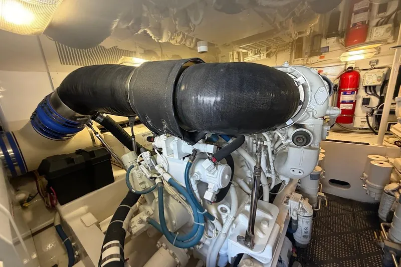Slide: The Image of Engine room of a 2012 Viking 50 Convertible yacht, showcasing complex machinery and components. - 55