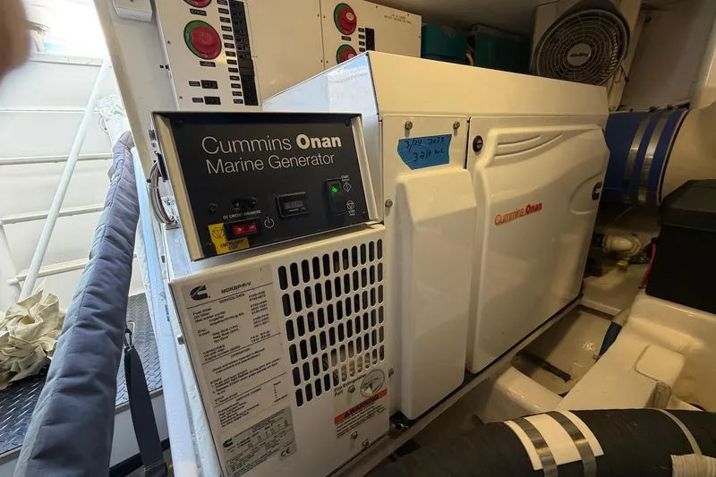 Slide: The Image of Cummins Onan marine generator in 2012 Viking 50 Convertible engine room. - 62