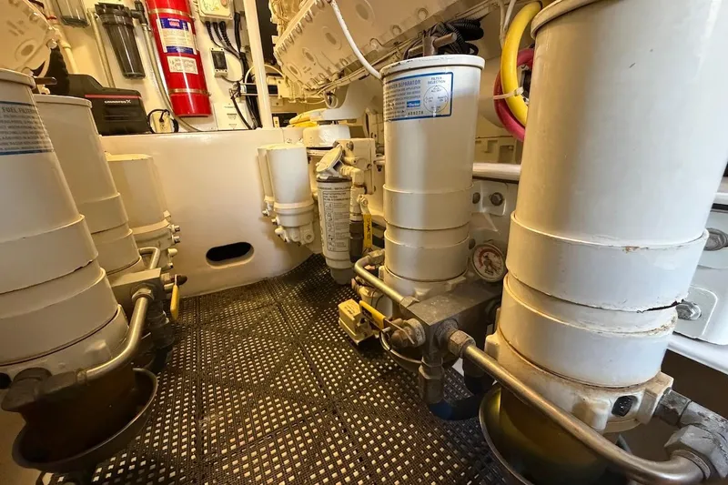 Slide: The Image of Engine room of a 2012 Viking 50 Convertible yacht, showcasing filters and equipment. - 65