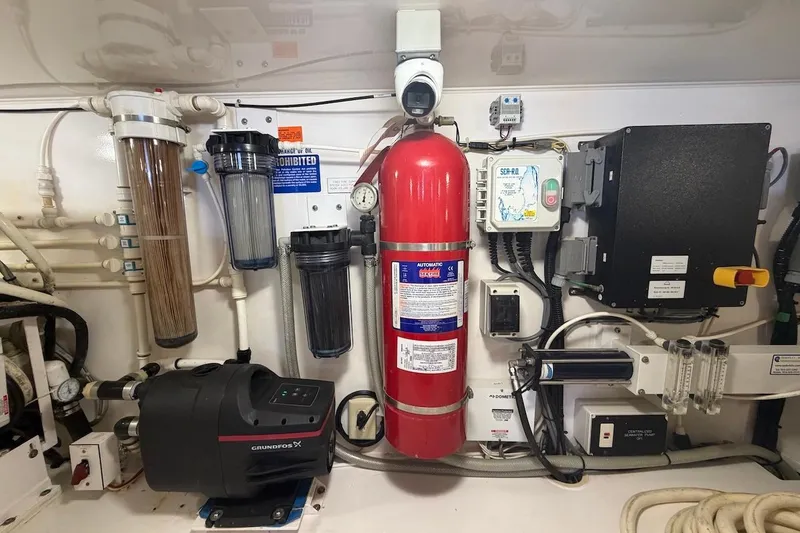 Slide: The Image of Engine room of a 2012 Viking 50 Convertible yacht with fire extinguisher and filtration system. - 66