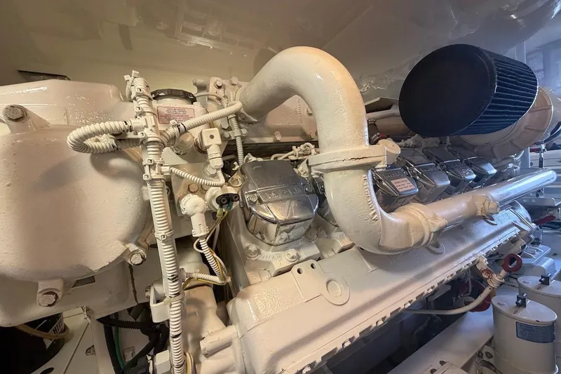 Slide: The Image of Engine room of a 2012 Viking 50 Convertible yacht, showcasing detailed machinery components. - 69