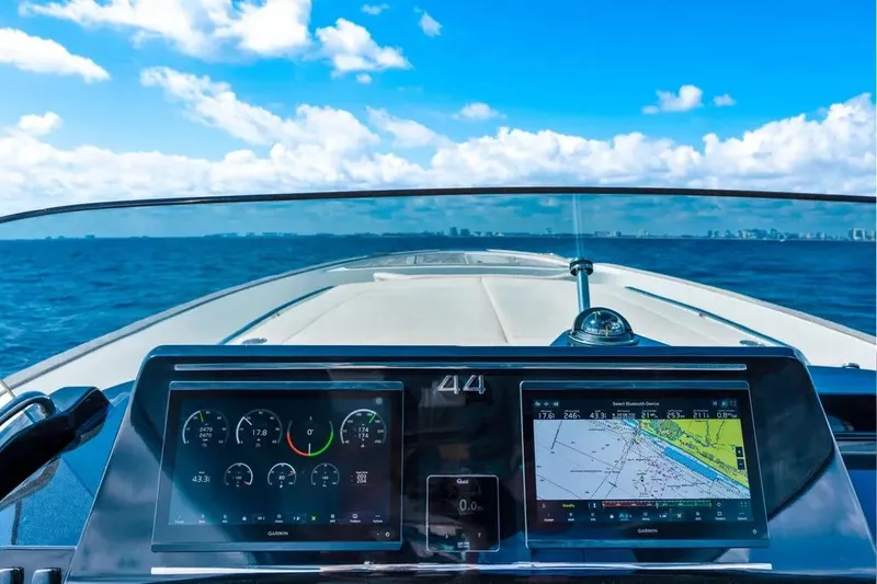Slide: The Image of 2024 Solaris Power 44 Open yacht dashboard with navigation screens, cruising on open sea. - 13