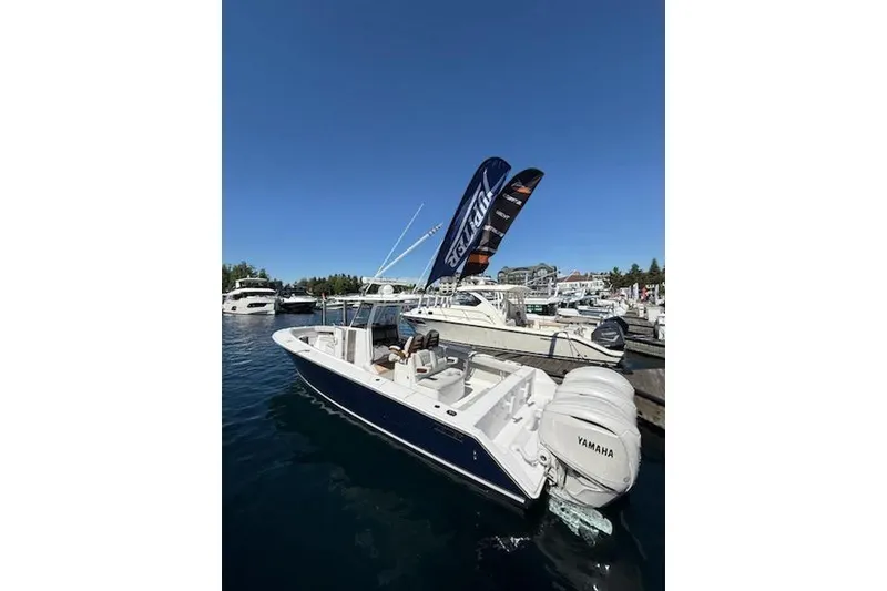 The Image of 2026 Jupiter 340LS boat docked with Yamaha engines, under clear blue sky. - 0