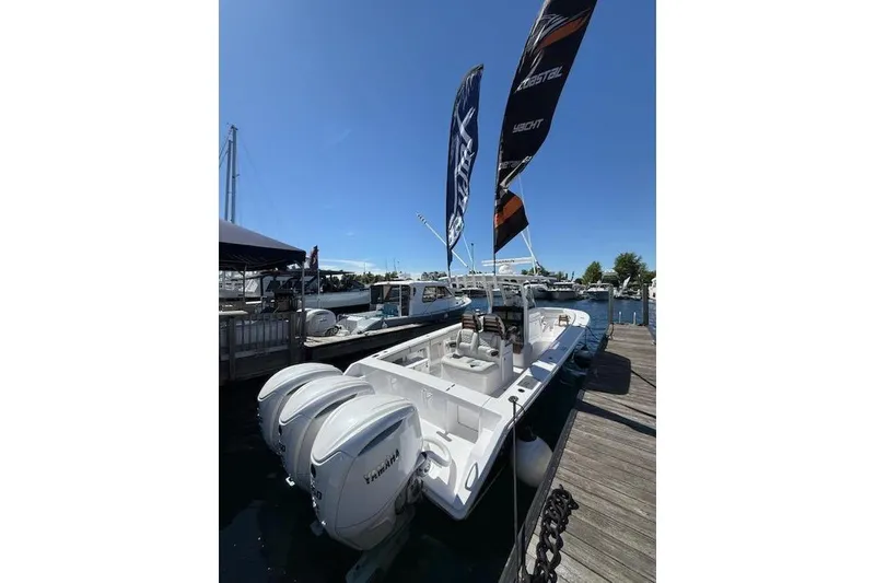 Slide: The Image of 2026 Jupiter 340LS boat docked with dual Yamaha engines and flags waving. - 1