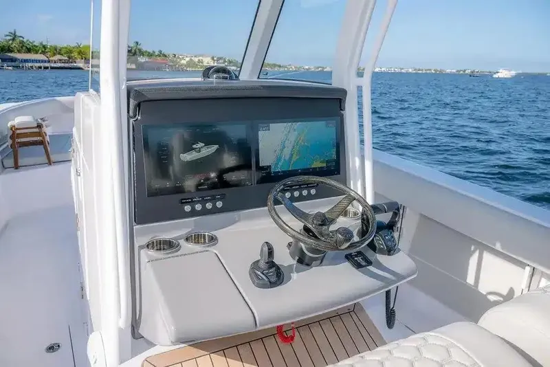 Slide: The Image of Manufacturer Provided Image: Helm of 2026 Jupiter 340LS boat with advanced navigation screens on open water. - 10