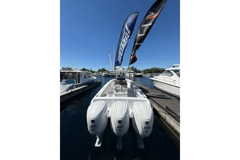 Slide: The Image of 2026 Jupiter 340LS boat with triple 350 engines docked at marina. - 2