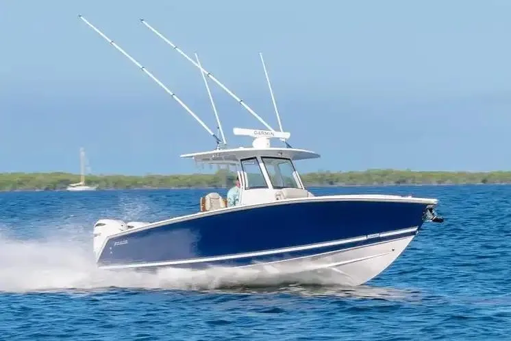 Slide: The Image of Manufacturer Provided Image: 2026 Jupiter 340LS boat cruising on open water under clear blue skies. - 5