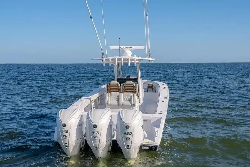 Slide: The Image of Manufacturer Provided Image: 2026 Jupiter 340LS boat with triple 350 V6 engines on open sea. - 7