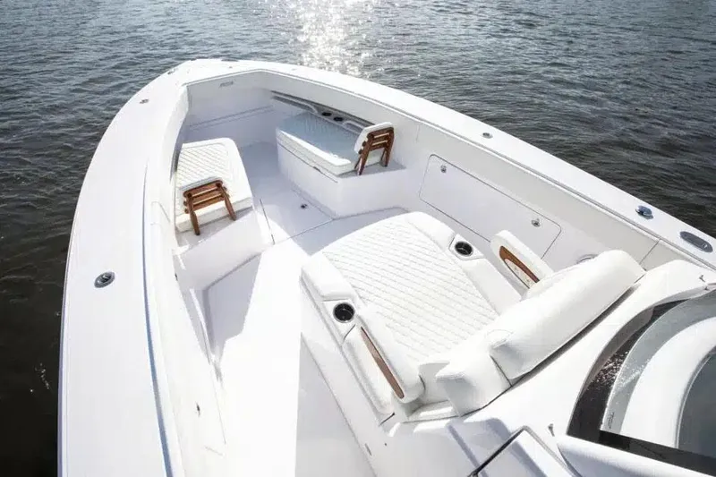 Slide: The Image of Manufacturer Provided Image: 2026 Jupiter 340LS boat with spacious white deck and seating on water. - 8