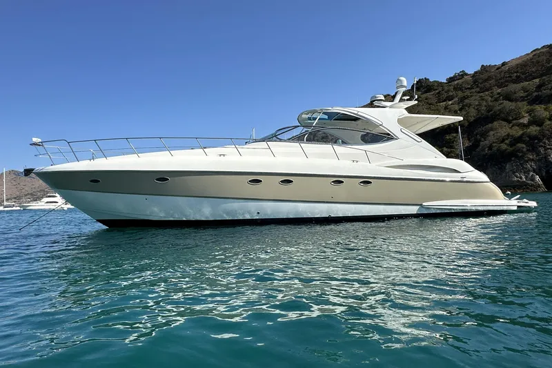 Slide: The Image of 2007 Cruisers Yachts 560 Express on serene water with scenic backdrop. - 0