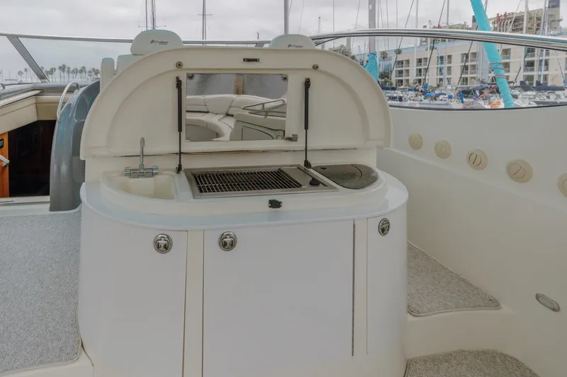 Slide: The Image of 2007 Cruisers Yachts 560 Express outdoor kitchen with grill and sink on deck. - 11