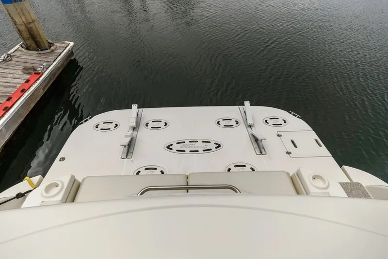 Slide: The Image of 2007 Cruisers Yachts 560 Express swim platform at dockside, showcasing water and mooring details. - 14