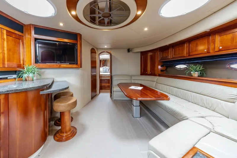 Slide: The Image of Luxurious interior of 2007 Cruisers Yachts 560 Express with elegant wood finishes and plush seating. - 15