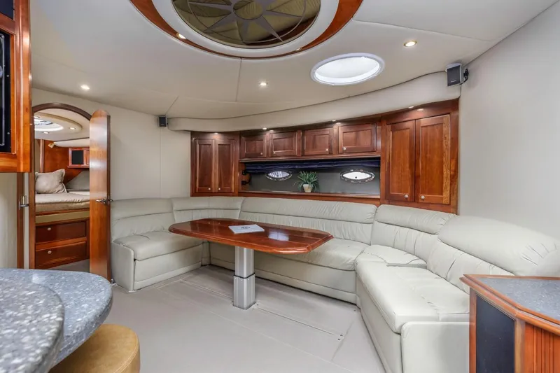 Slide: The Image of Luxurious interior of 2007 Cruisers Yachts 560 Express with elegant seating and wooden cabinetry. - 16