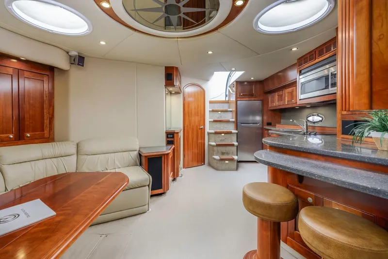 Slide: The Image of Luxurious interior of 2007 Cruisers Yachts 560 Express with modern kitchen and seating area. - 19