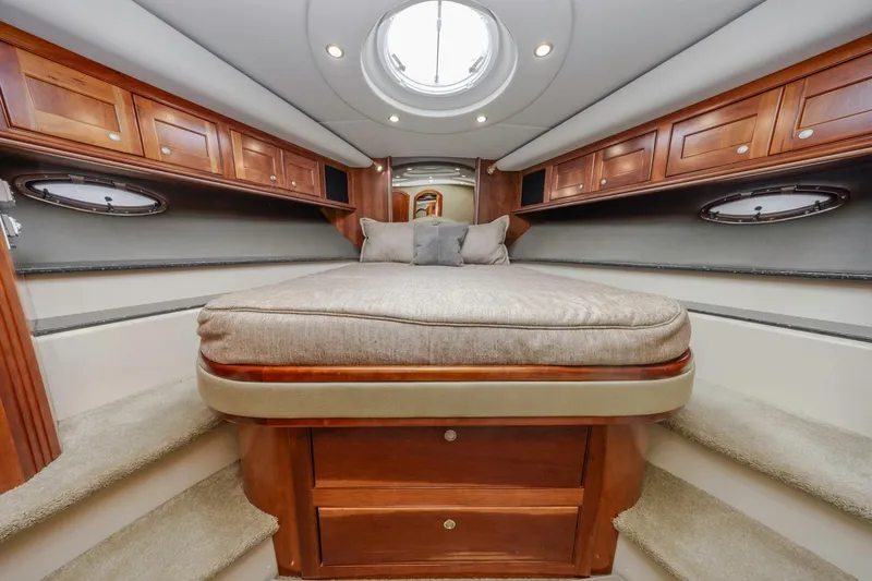 Slide: The Image of Luxurious 2007 Cruisers Yachts 560 Express cabin with elegant wood cabinetry and plush bedding. - 21