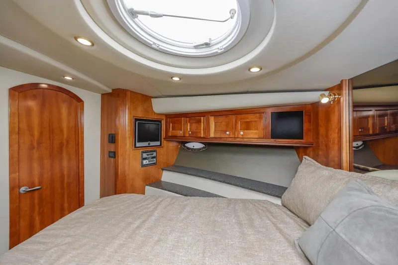 Slide: The Image of Luxurious cabin interior of 2007 Cruisers Yachts 560 Express with wood finish and porthole. - 22
