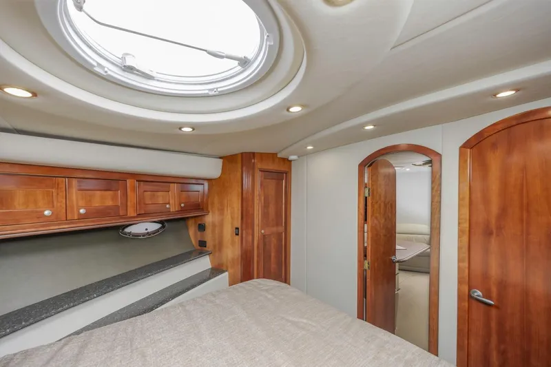 Slide: The Image of Luxurious interior of 2007 Cruisers Yachts 560 Express with wood accents and circular skylight. - 23