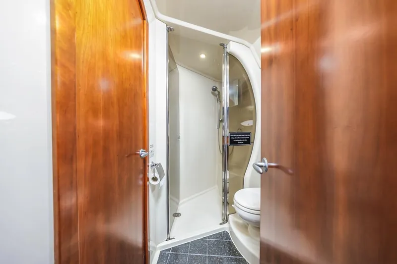 Slide: The Image of Luxurious bathroom in 2007 Cruisers Yachts 560 Express with wooden doors and modern shower. - 24